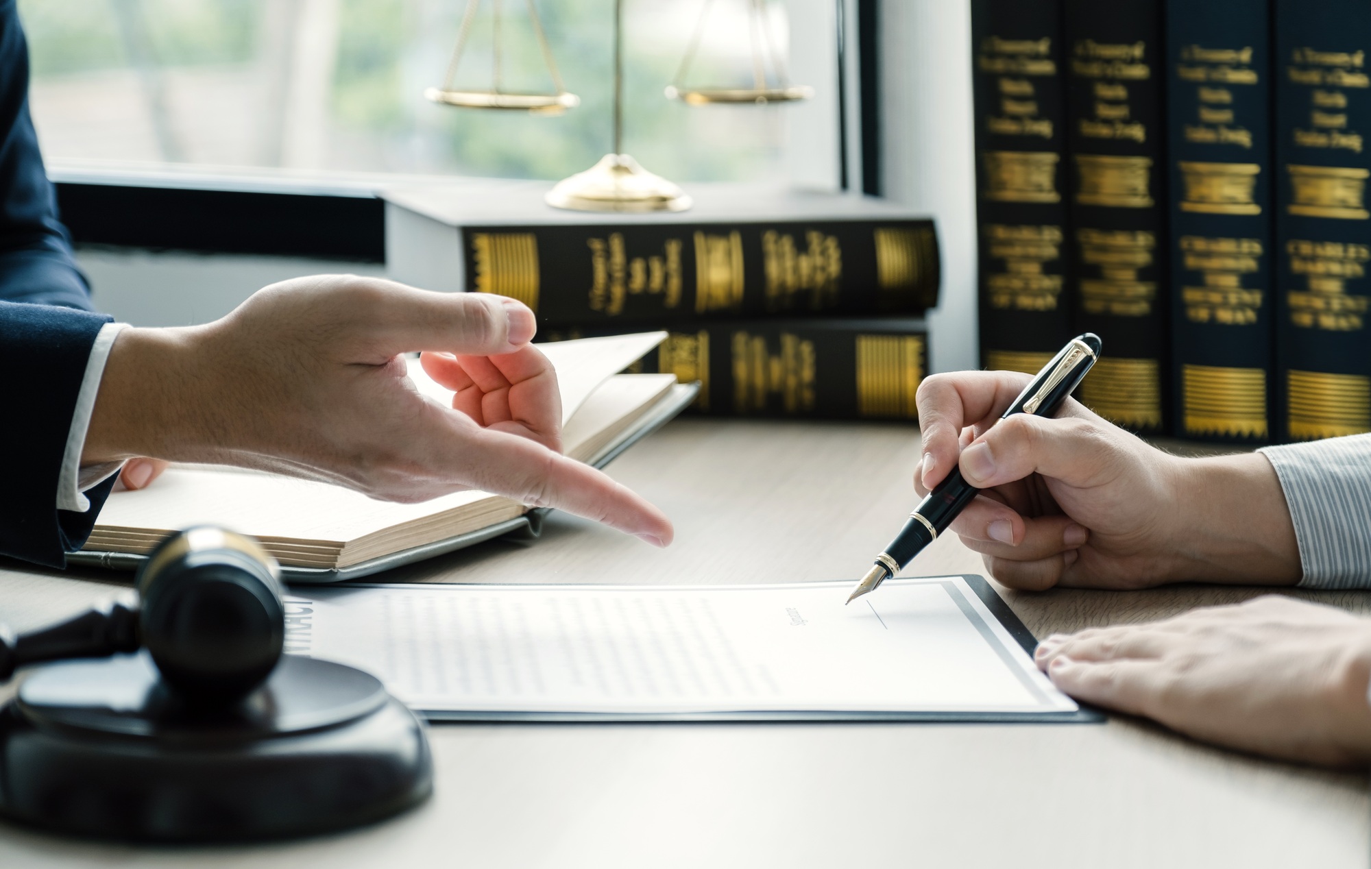 Businessman hand sign after Lawyer providing legal consult dispute service at the office